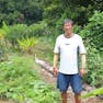 Photo of Mr Tang standing in a garden field