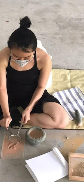 Sieving dried and grounded soil