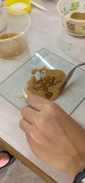 Mixing dried and sieved soil with clove oil and other liquids to form pigments