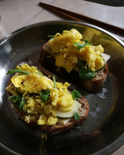 Scrambled eggs and veggies on toast