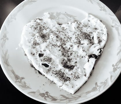 A plate of sourdough with a piece bitten off.