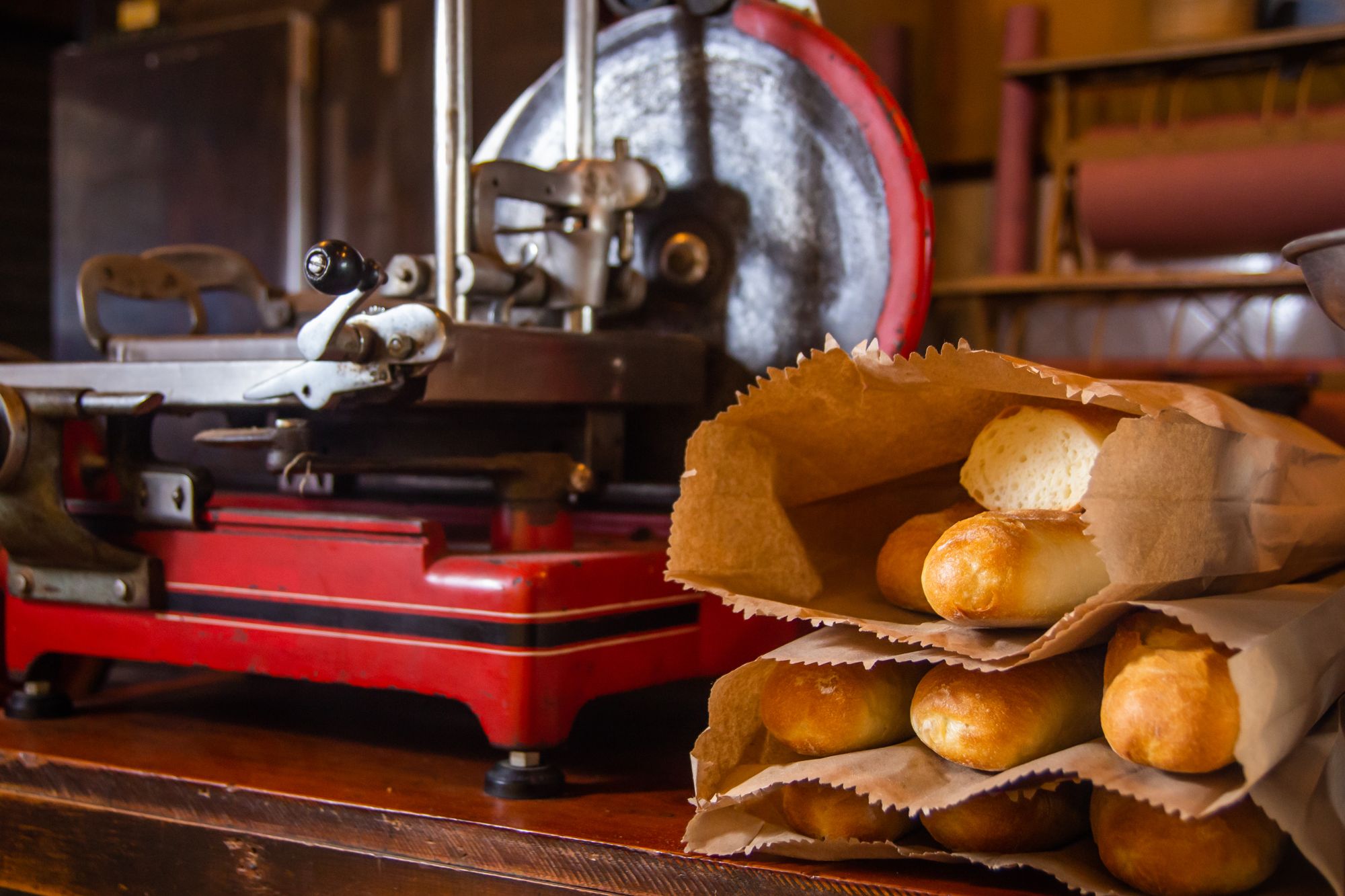 Fresh baguettes wrapped in paper bags ready for collection