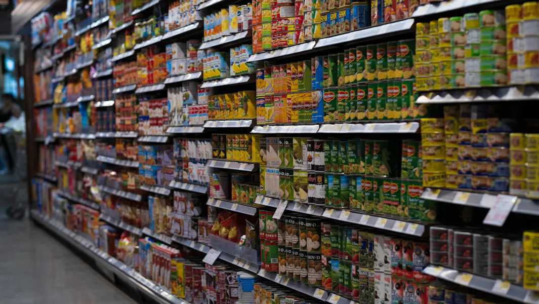 Two dates, two meanings Supermarket aisle shelves stocked with canned goods