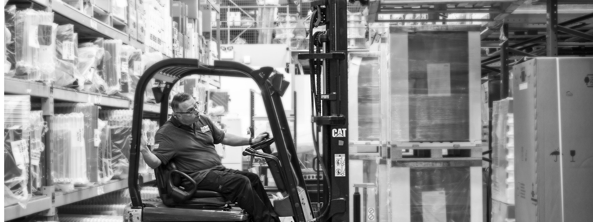 Forbes Professional employee re-stocking warehouse.