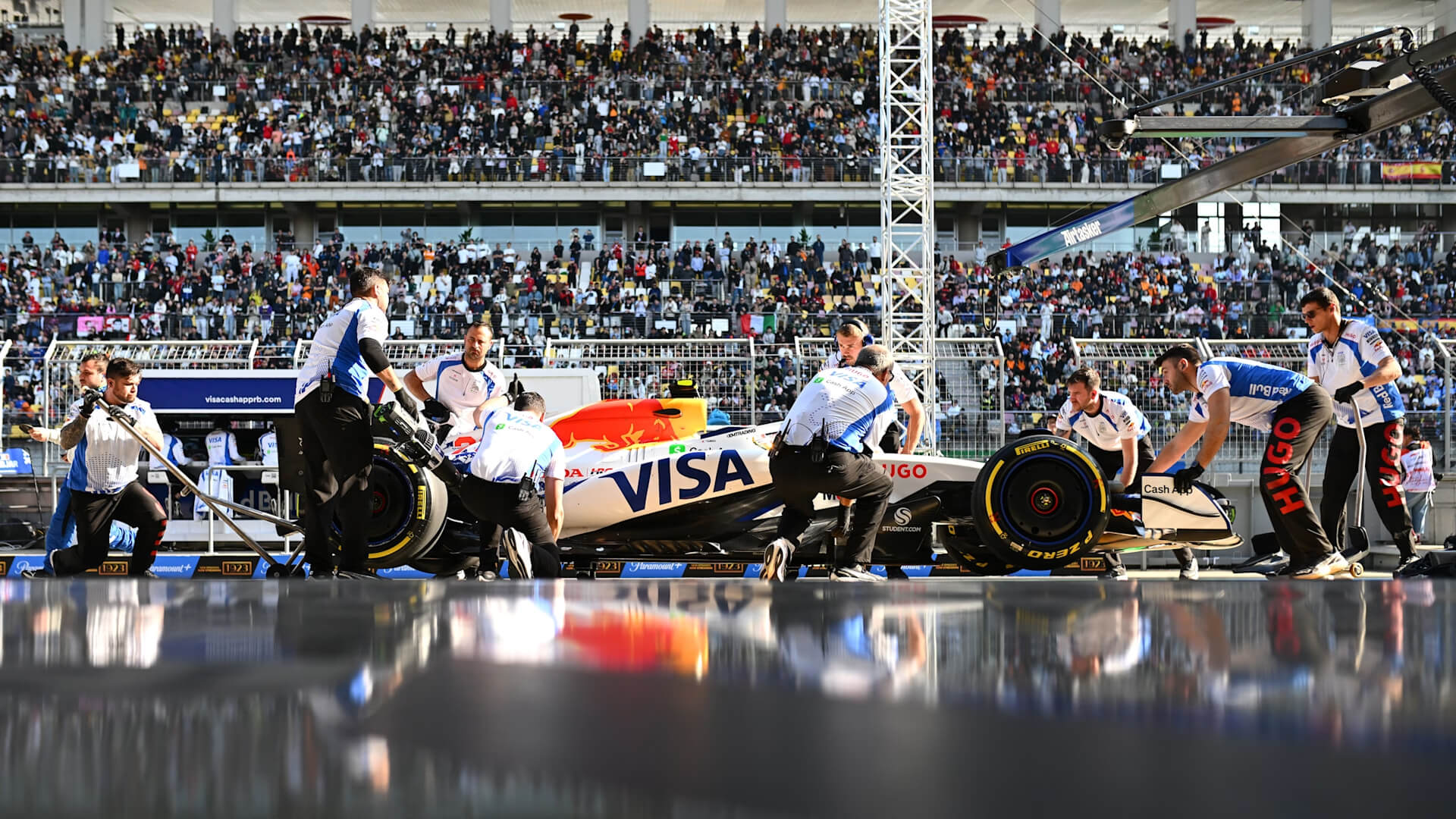 Racing Bulls team at work in the pit lane at the Shangai circuit