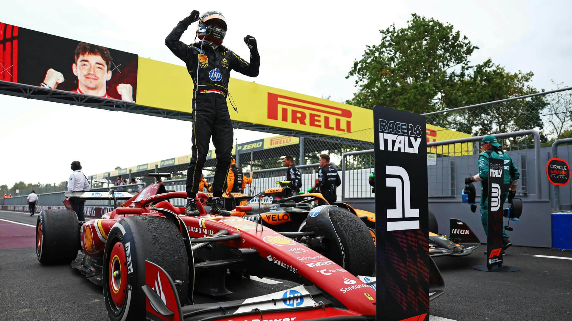 Leclerc standing on his car at the finish in the parc fermé