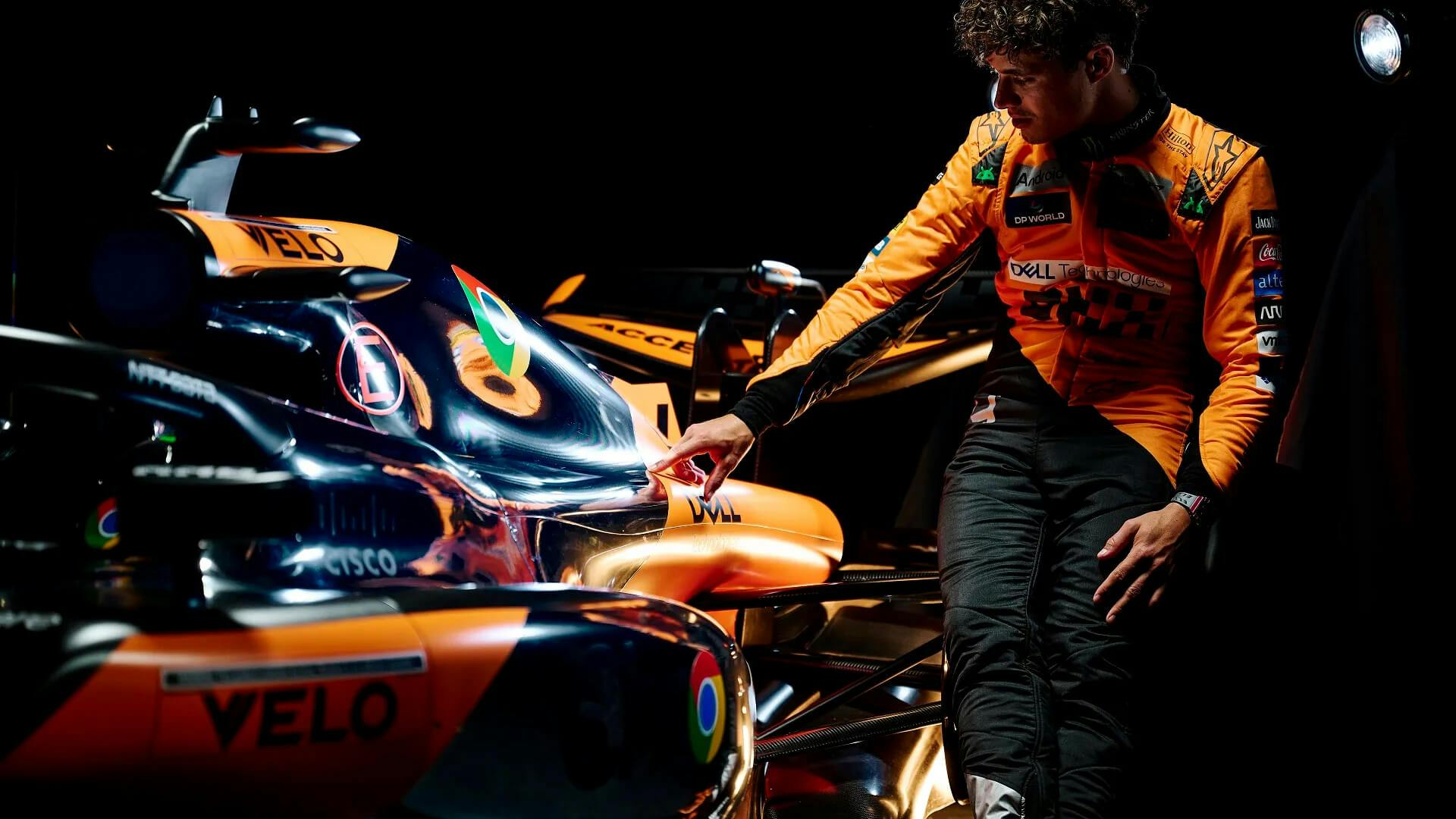 Norris touches the bodywork of the McLaren F1 MCL38 with a 2nd edition of the special Chrome livery