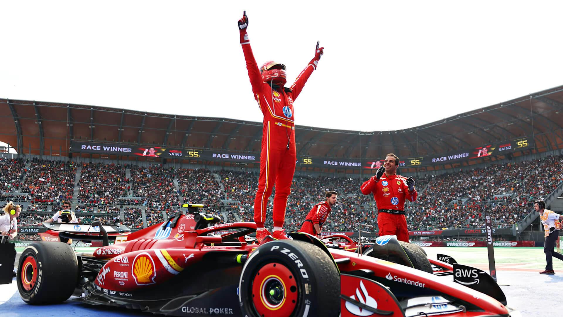 Sainz victorious standing on his Ferrari SF-24 at Mexican GP