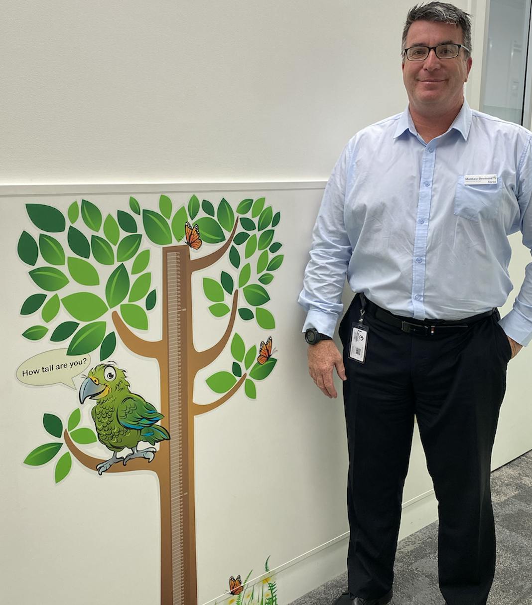 Photo of Patient Services Manager Matt Devonald with the new height chart