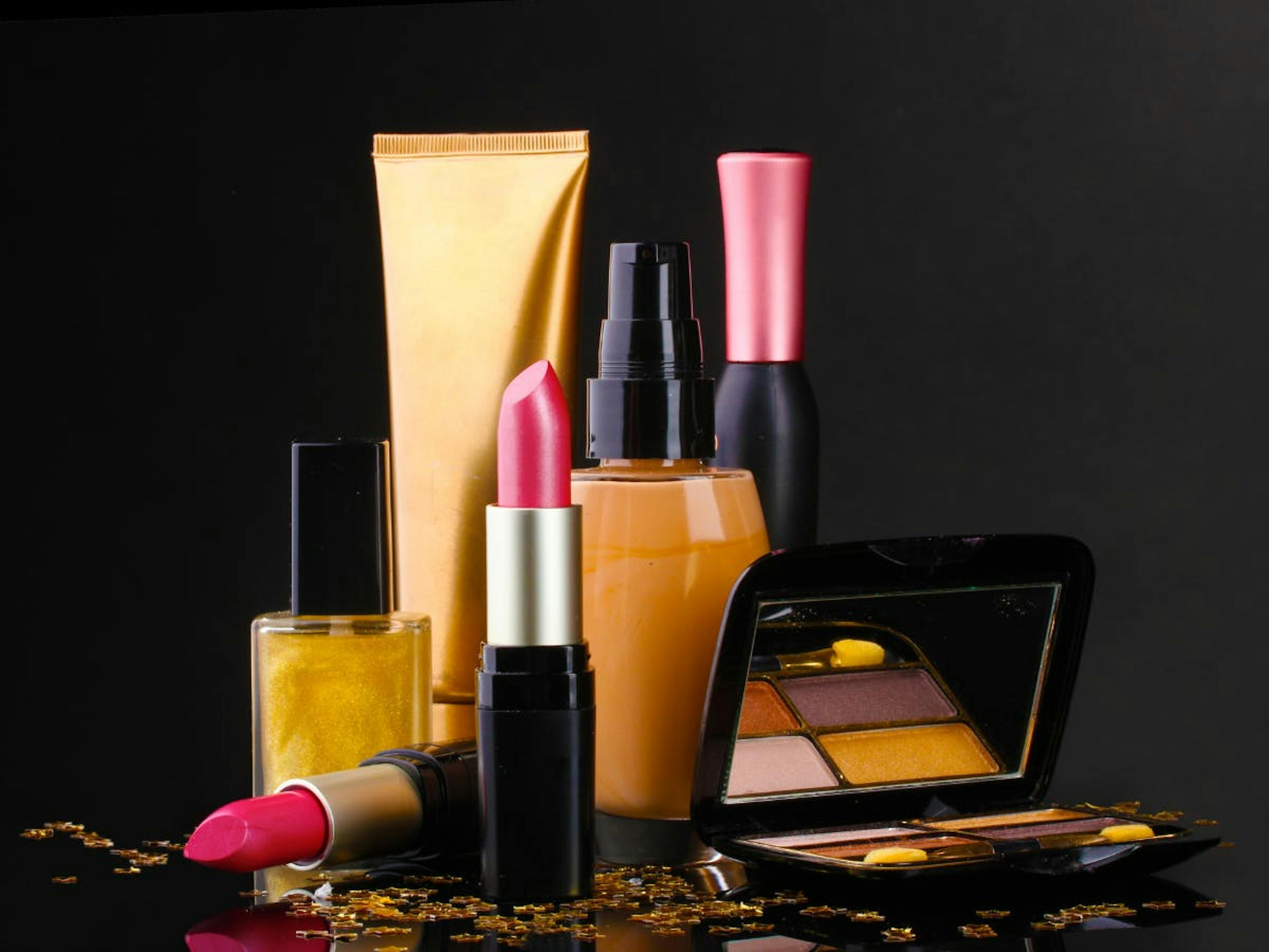 A couple of make-up products over a dark background. 