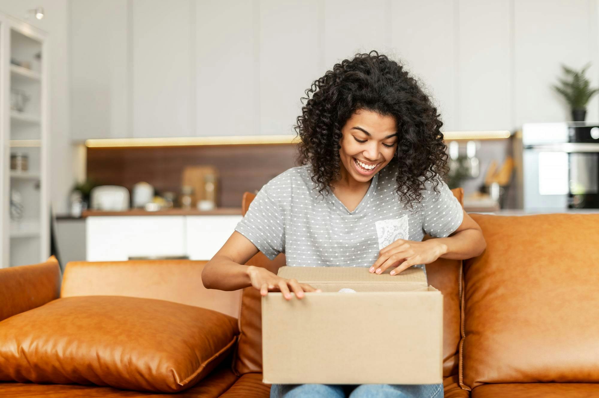 A woman is smiling to get her packages from the US