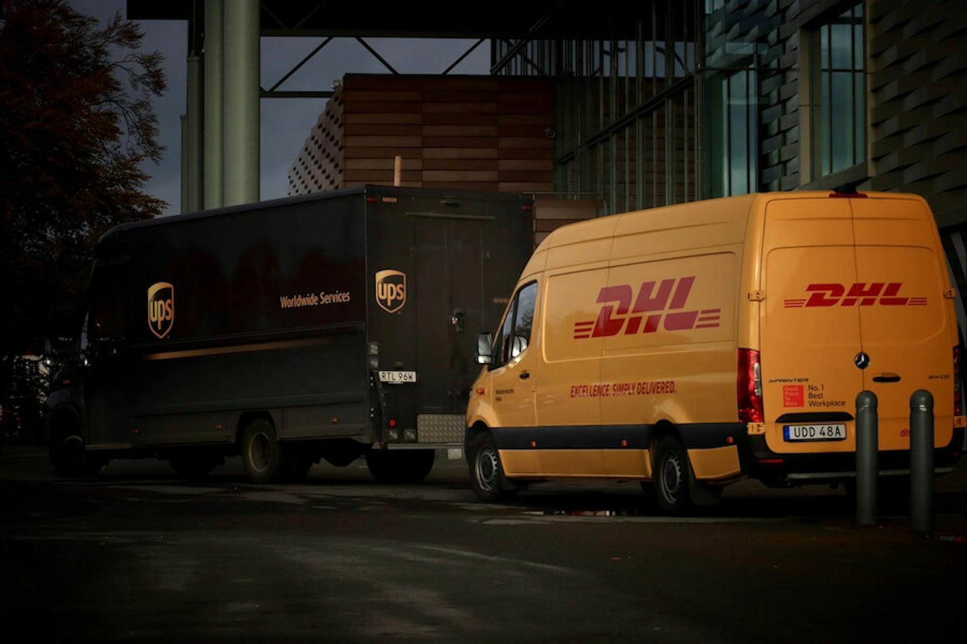 DHL Express and UPS trucks are on the road
