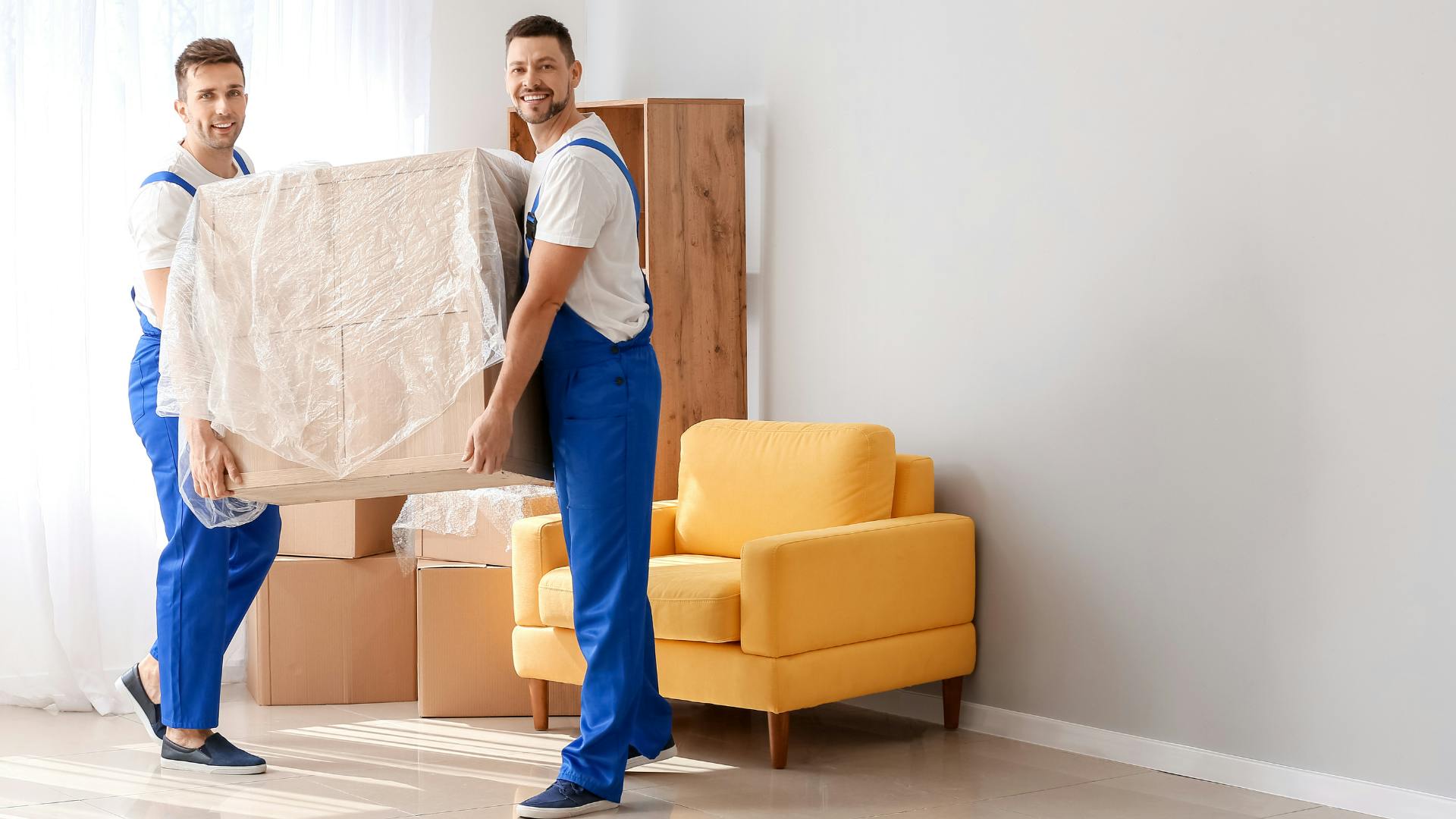 Loaders carrying furniture to a flat. 