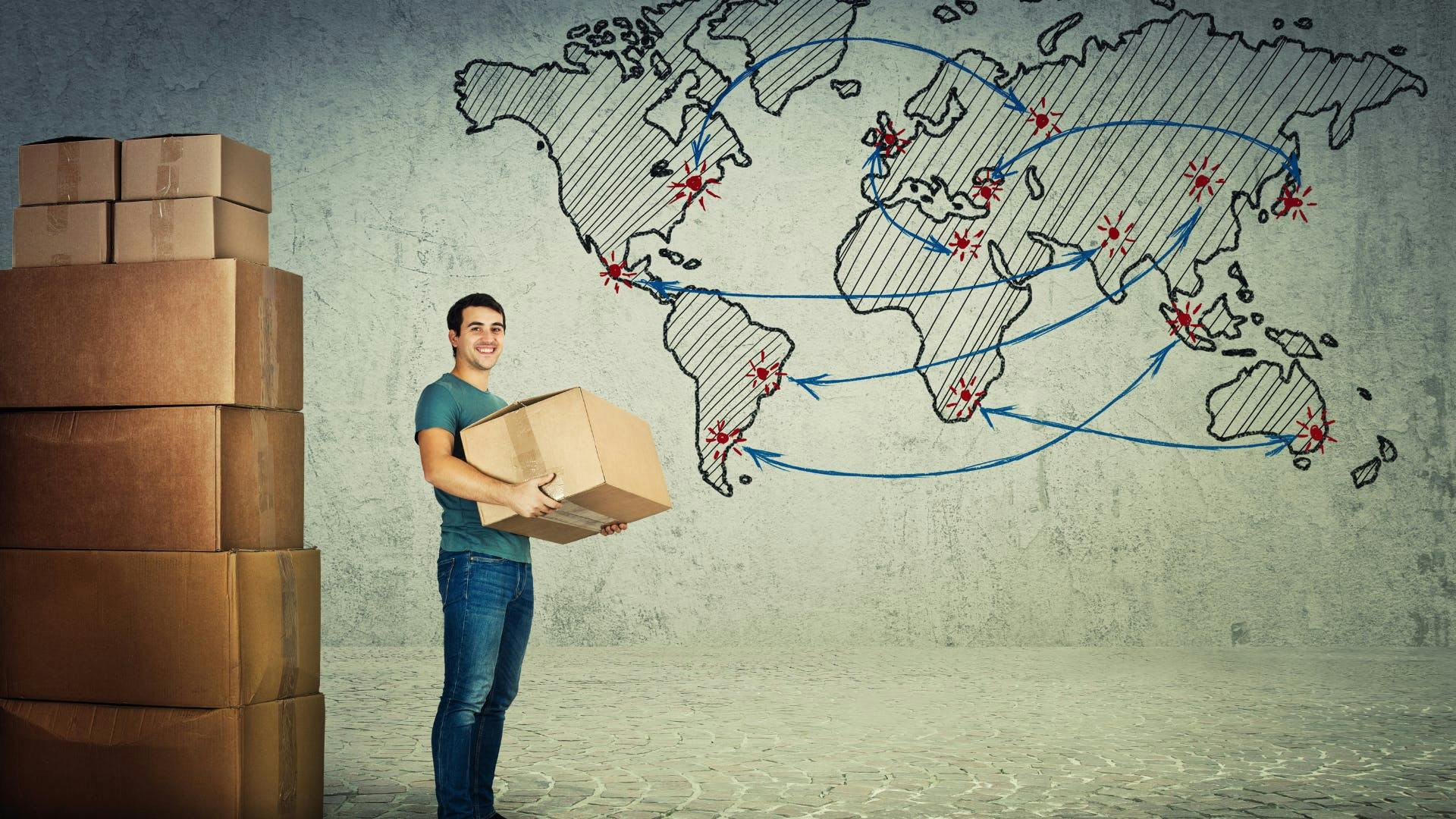 A man carrying a package in front of the world map.