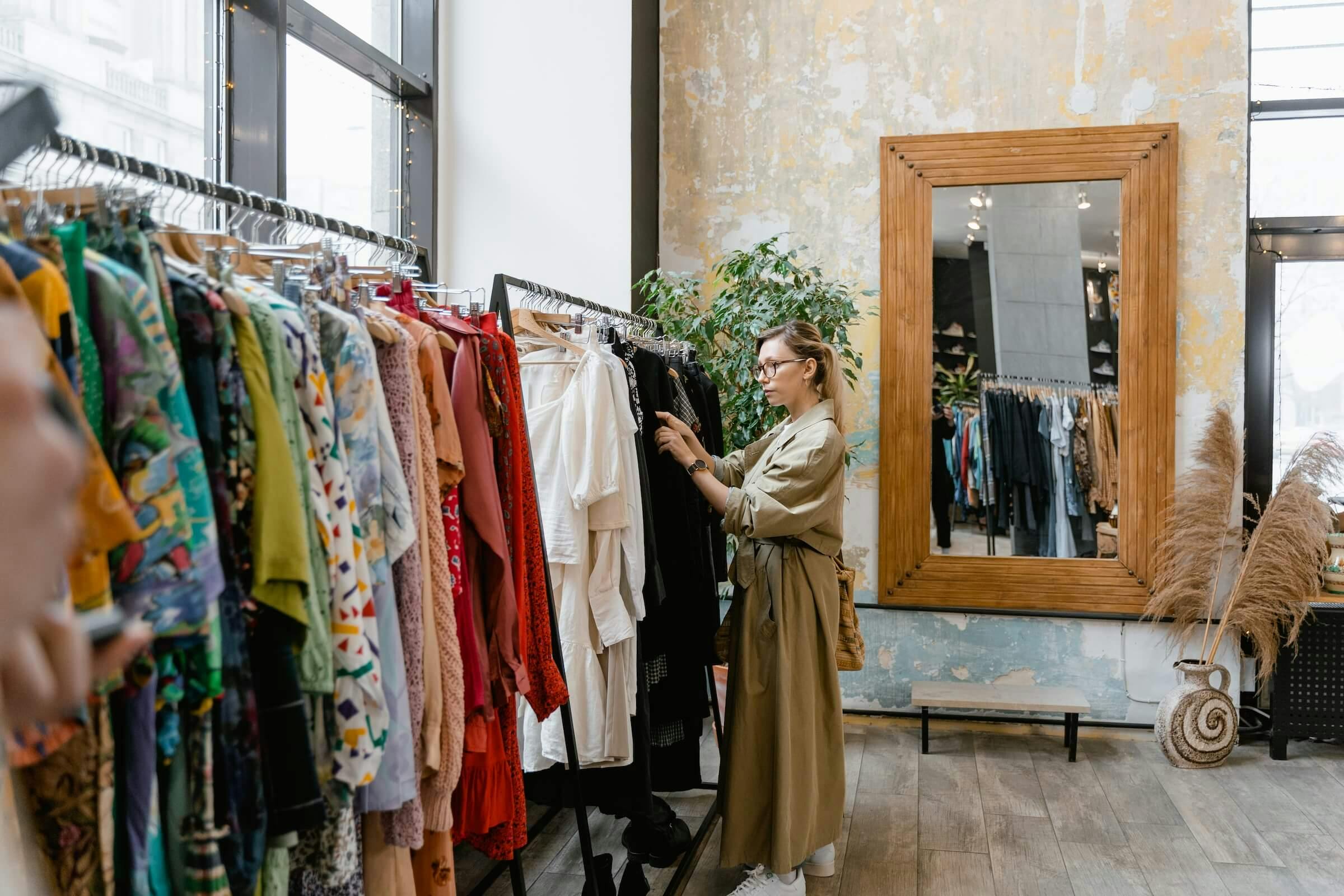 woman shopping fashion from the rack of clothing in a vintage retail center
