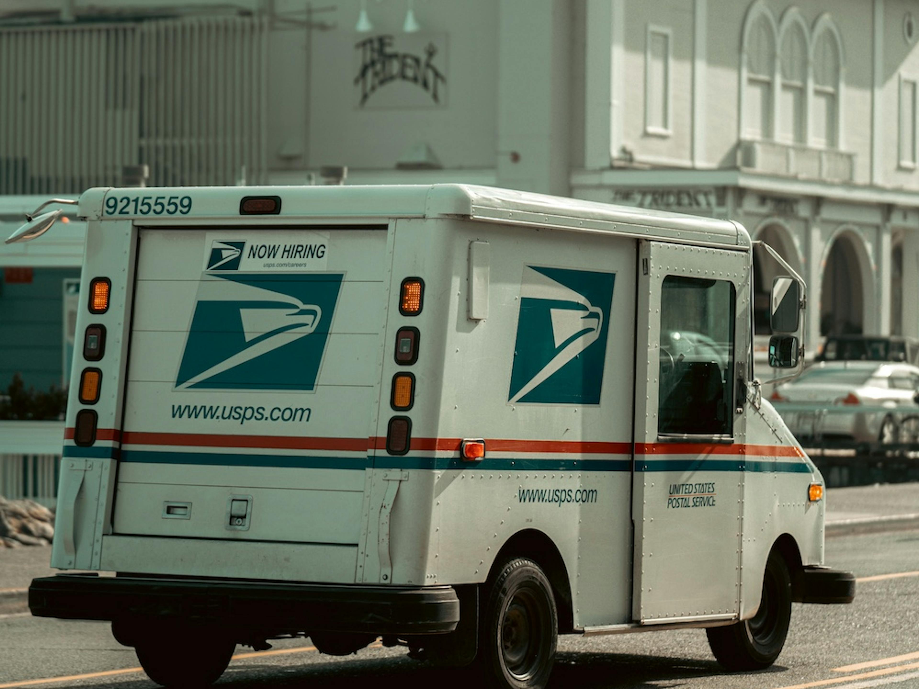 USPS delivery truck on the road