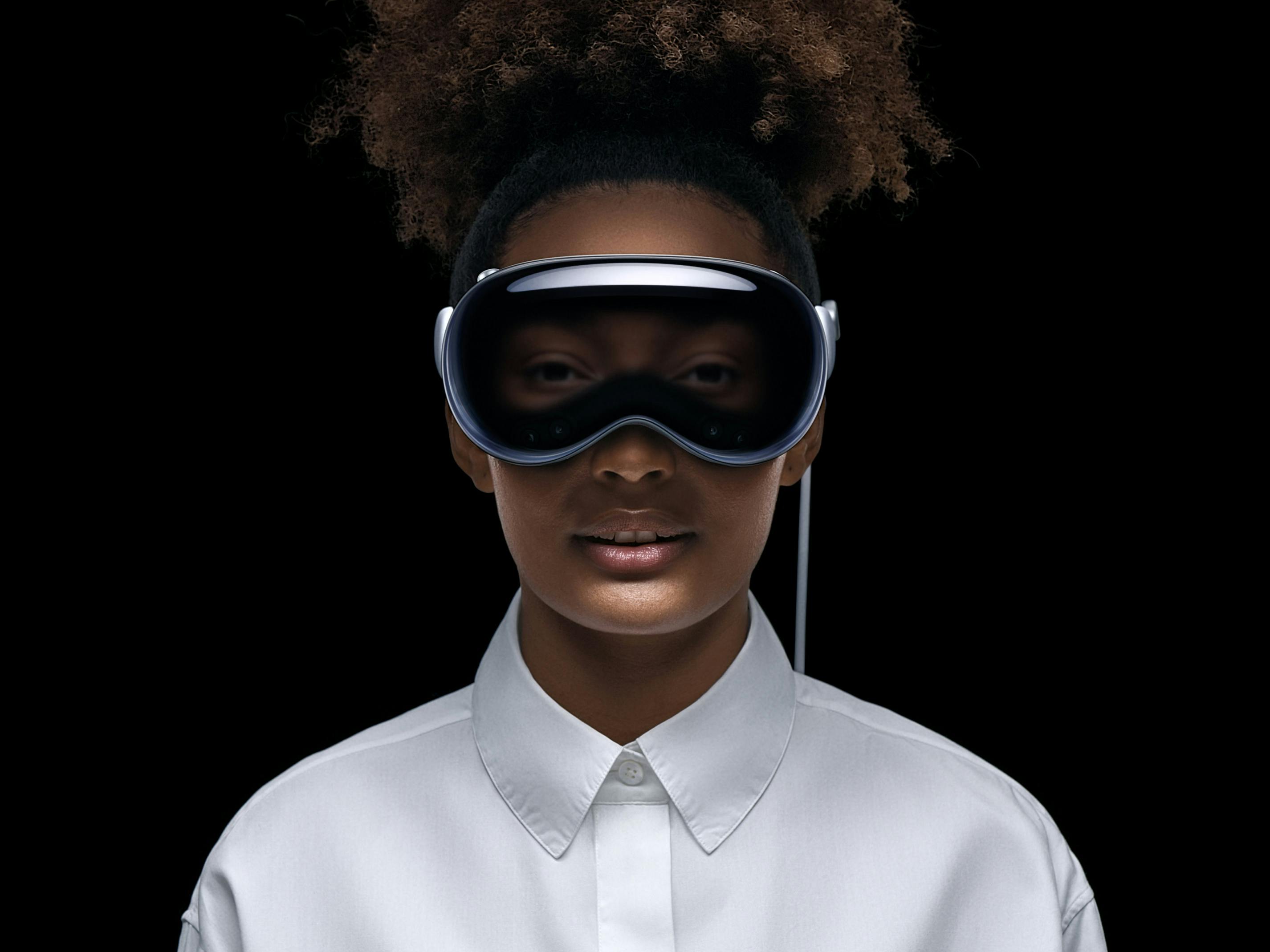 A woman wears Apple Vision Pro 