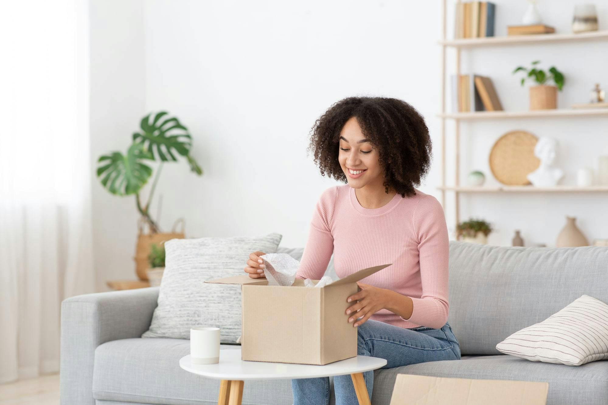 A woman is smiling to get her package from US store A woman is smiling to get her package from US store