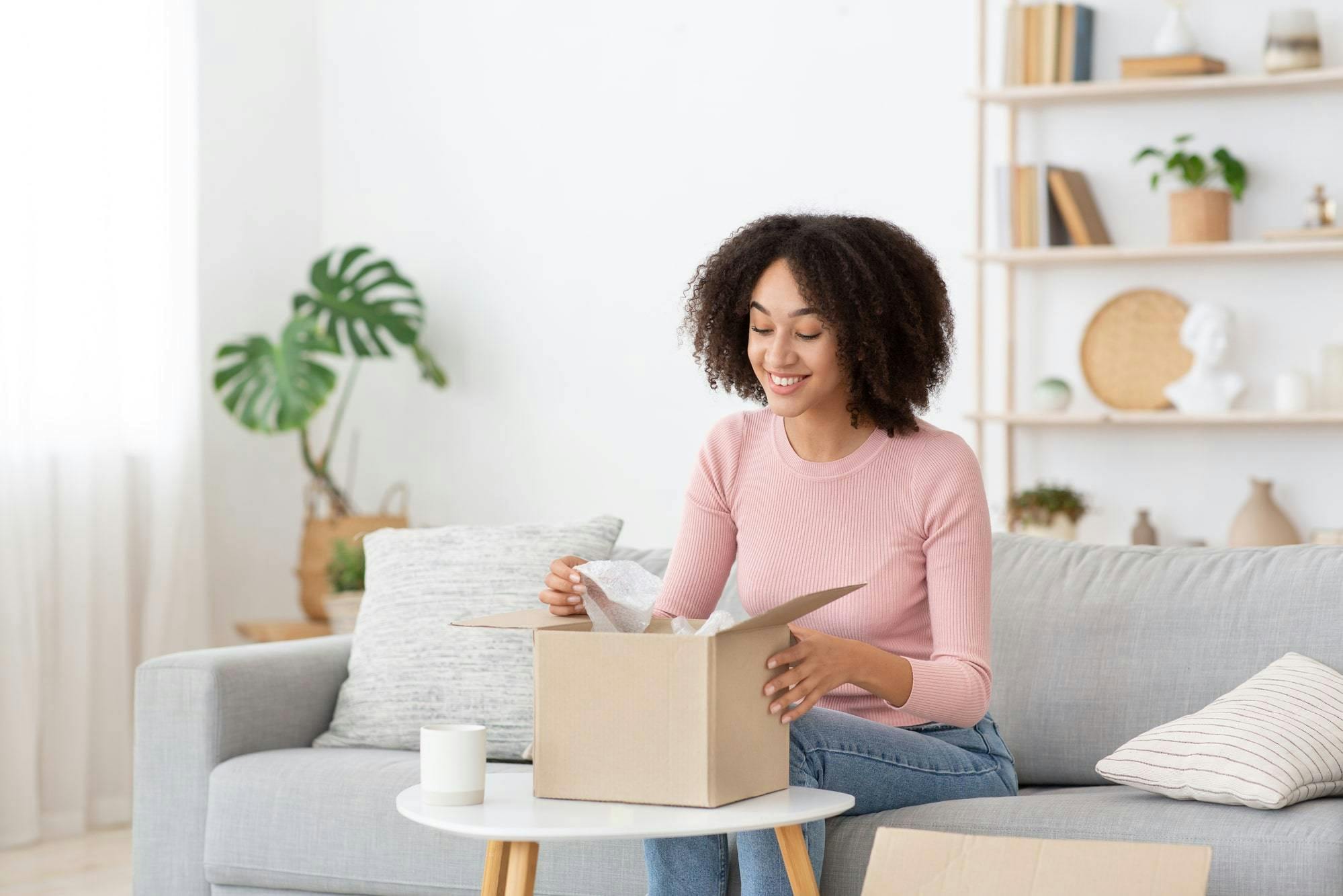 A woman is smiling to get her package from US store