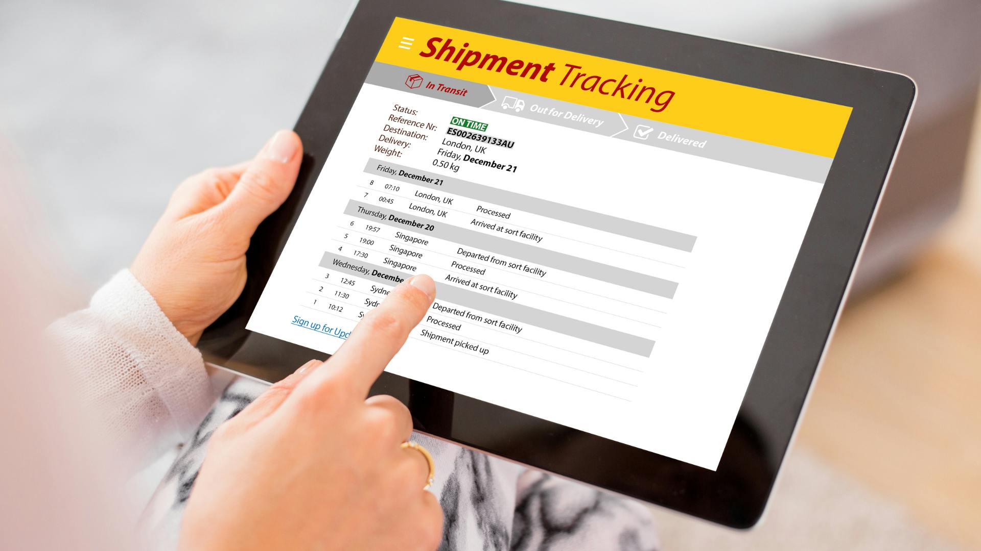 A person tracking the package via it's tracking number on a tablet.