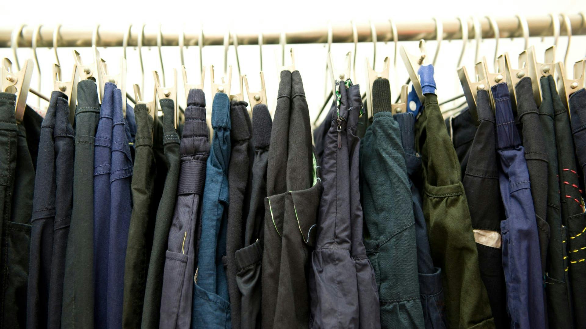 A clothing rack full of pants. A clothing rack full of pants.