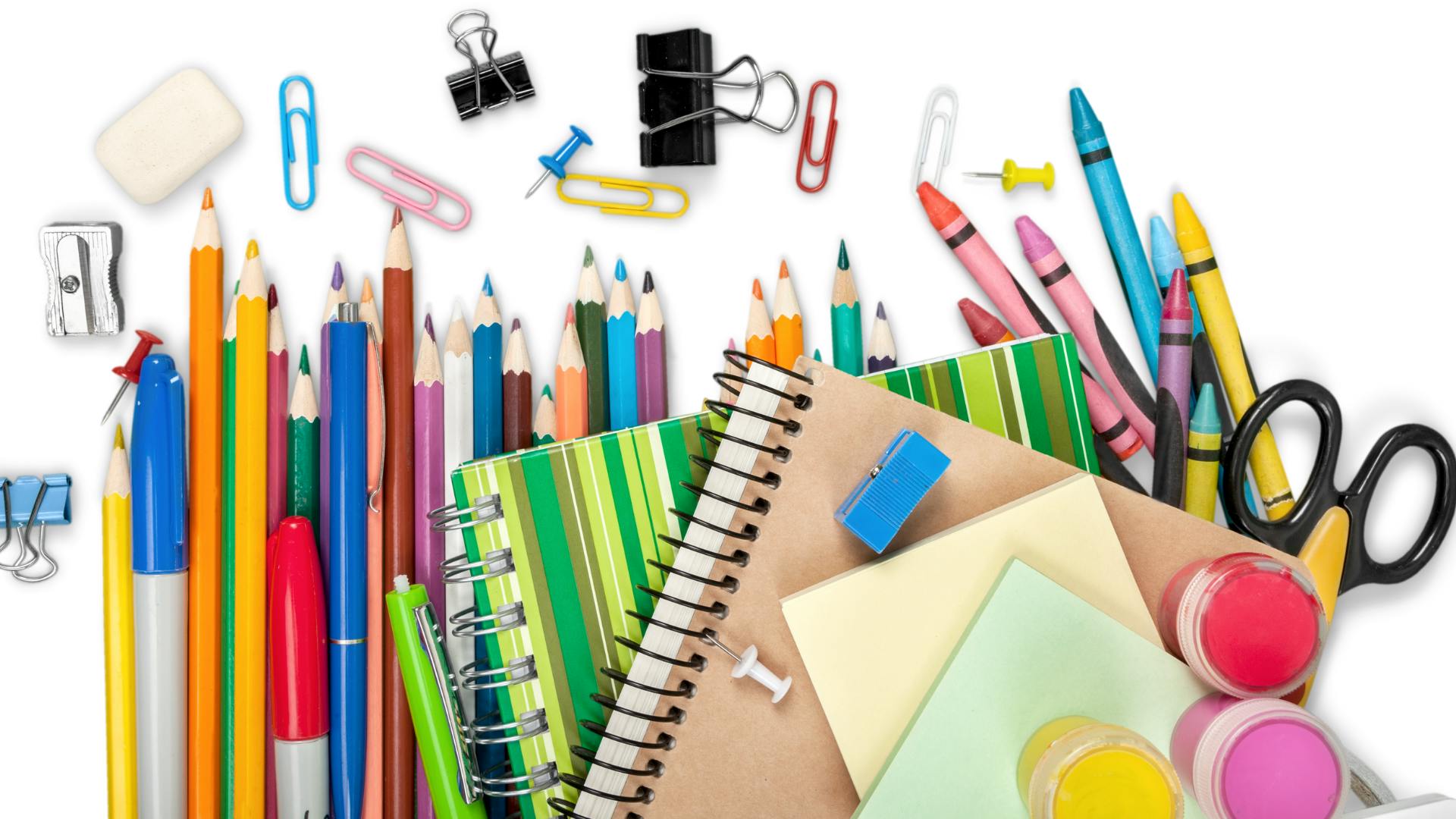 Different kind of school supplies on a white background.