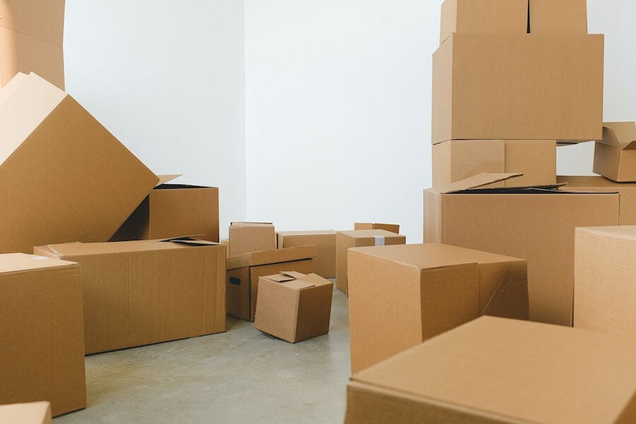 many boxes are stacked up in an empty room, in the style of online sculpture,