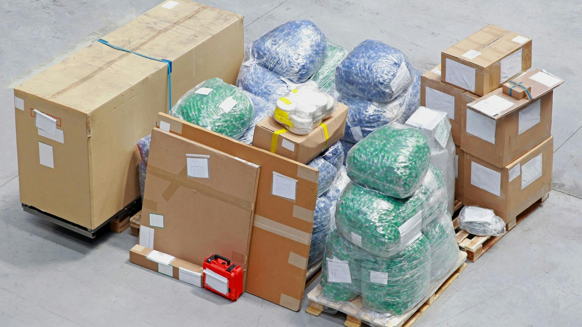 Shipping packages stacked, and leaned on each as they are ready to be shipped.