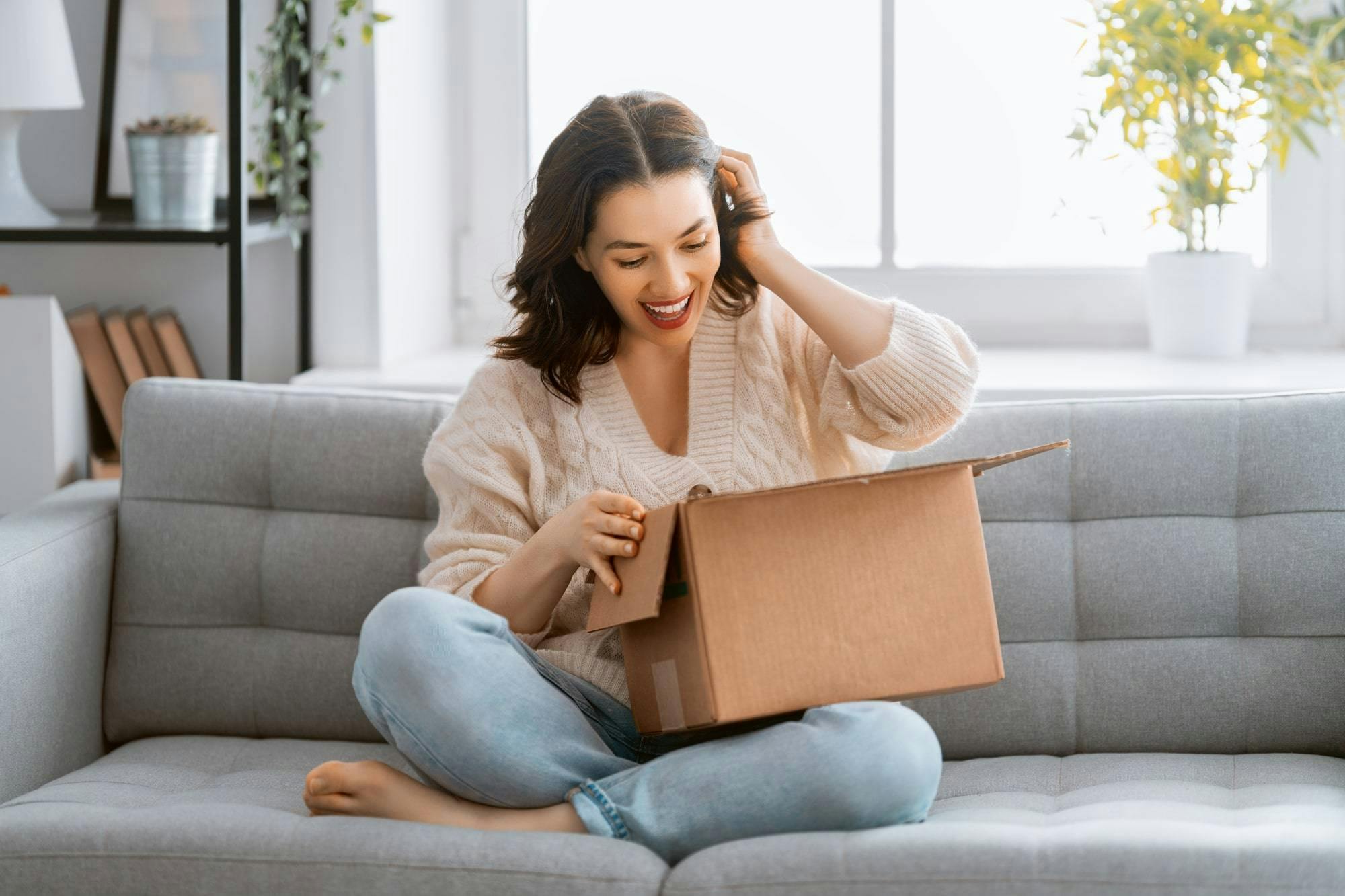 A woman is smiling as she received her package without any problems