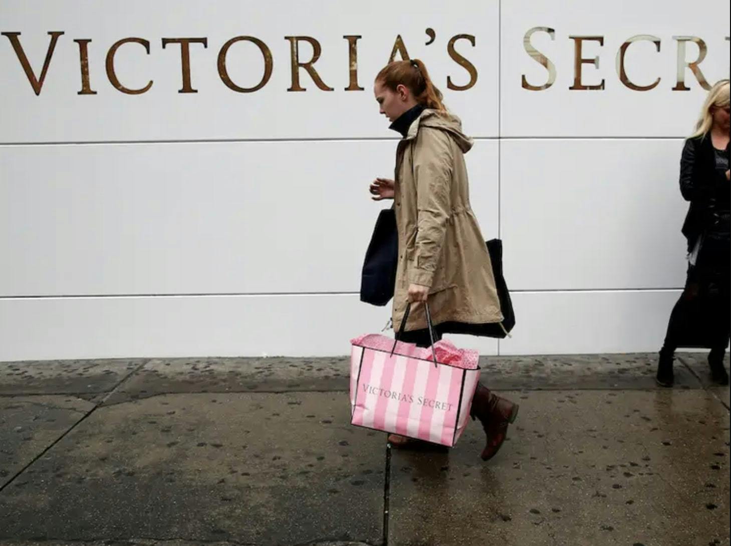 A woman with Victoria's Secret shopping bag.