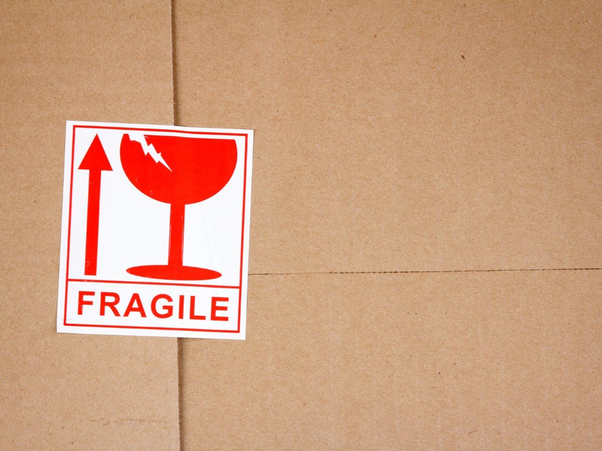 A fragile sticker on top of a shipping package. 