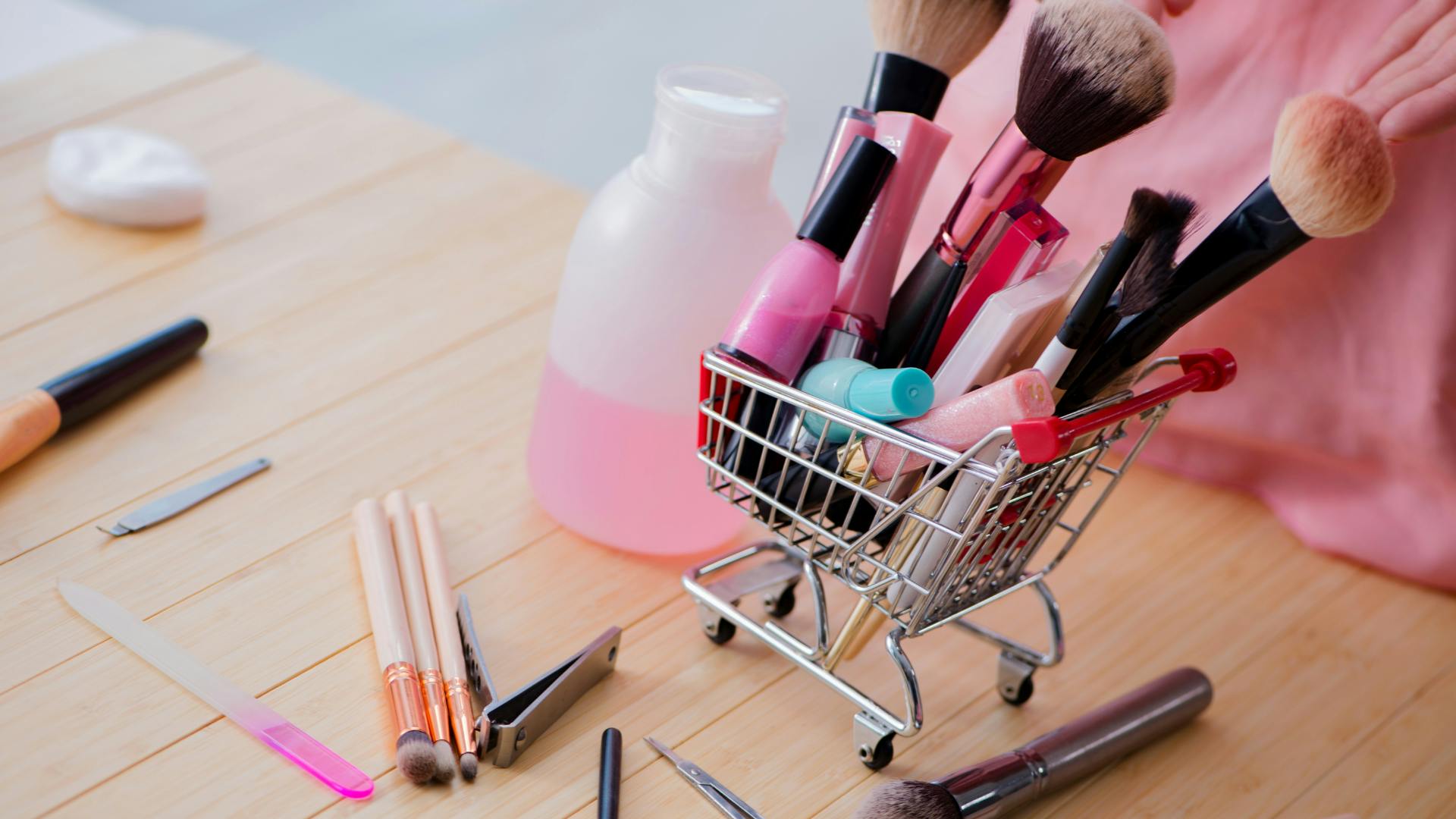 A mini shopping cart full of beauty products. 