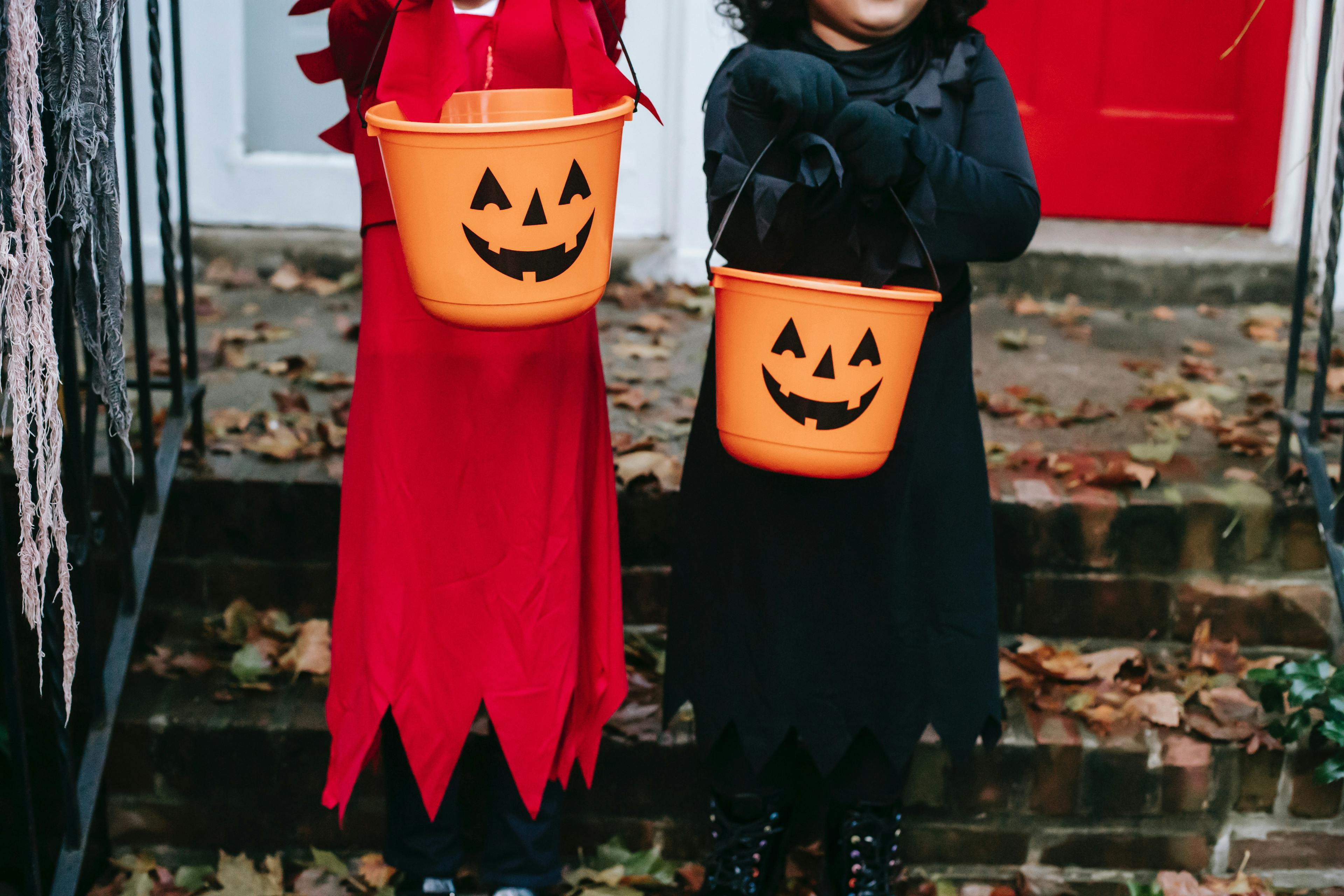 Children carrying Halloween candy bags.