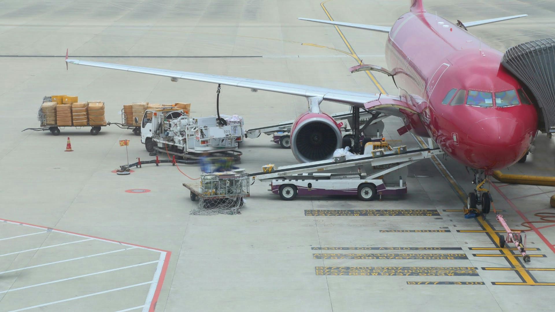 A commercial shipment plain is loading with packages. A commercial shipment plain is loading with packages.