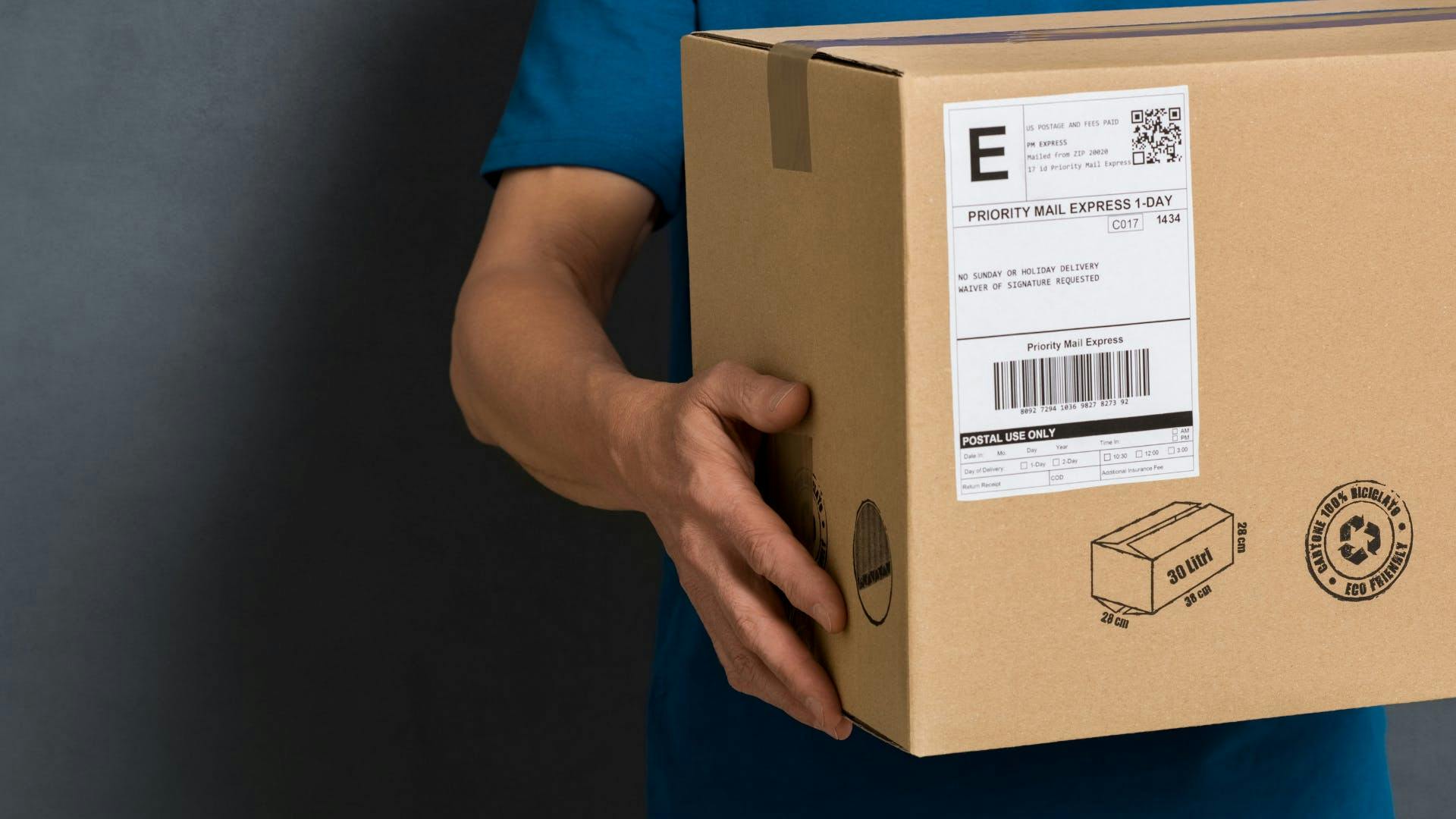 A man holding shipping package.