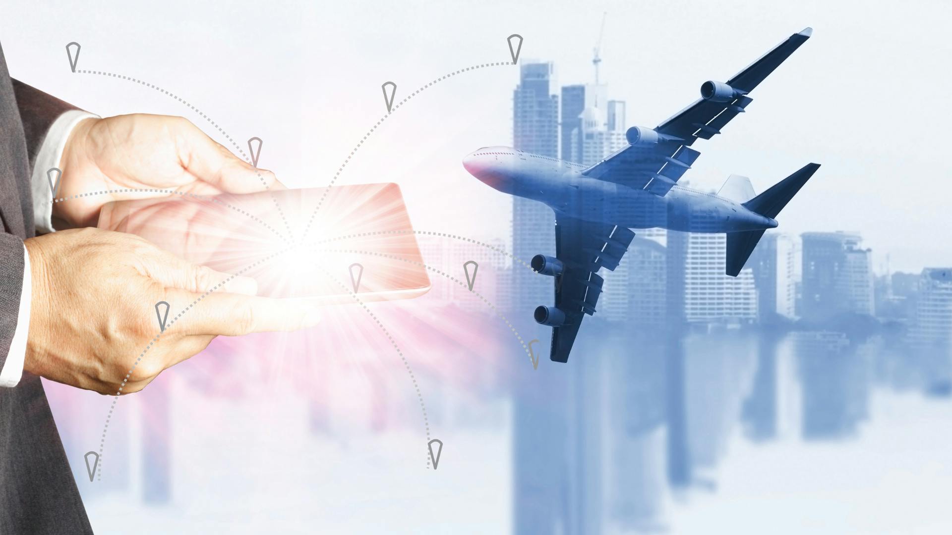 A man holding a tablet, and a plain flying over a city on the background. 