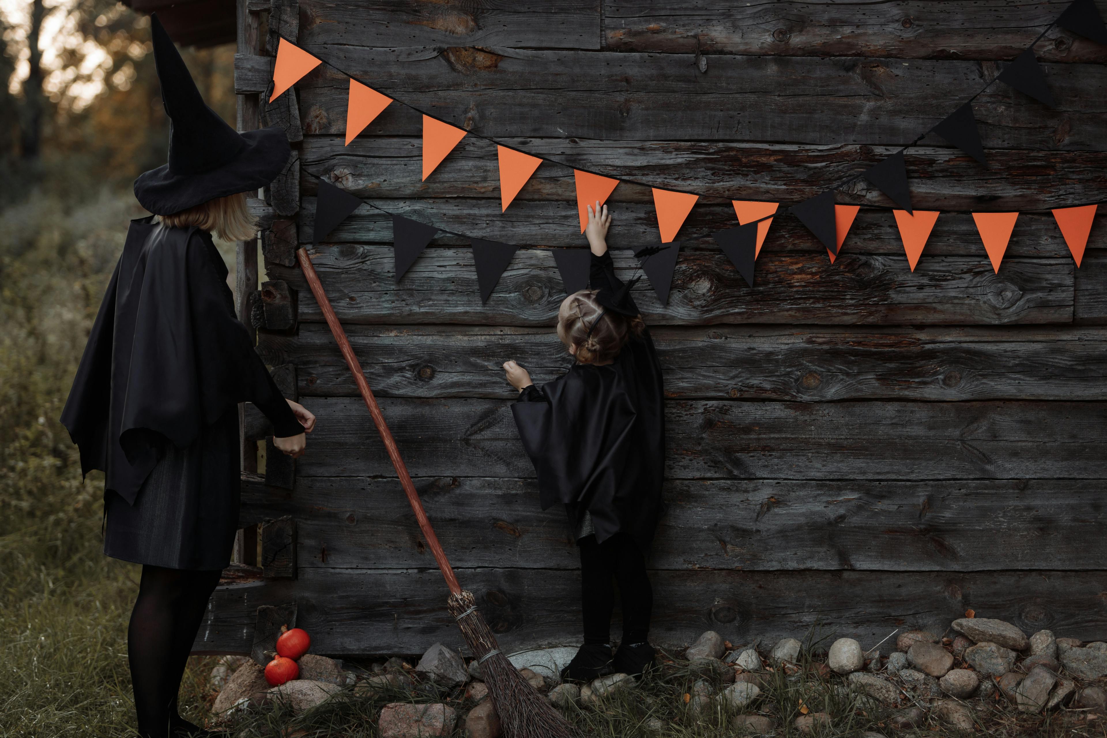 An adult and a child wearing Halloween costumes. An adult and a child wearing Halloween costumes.