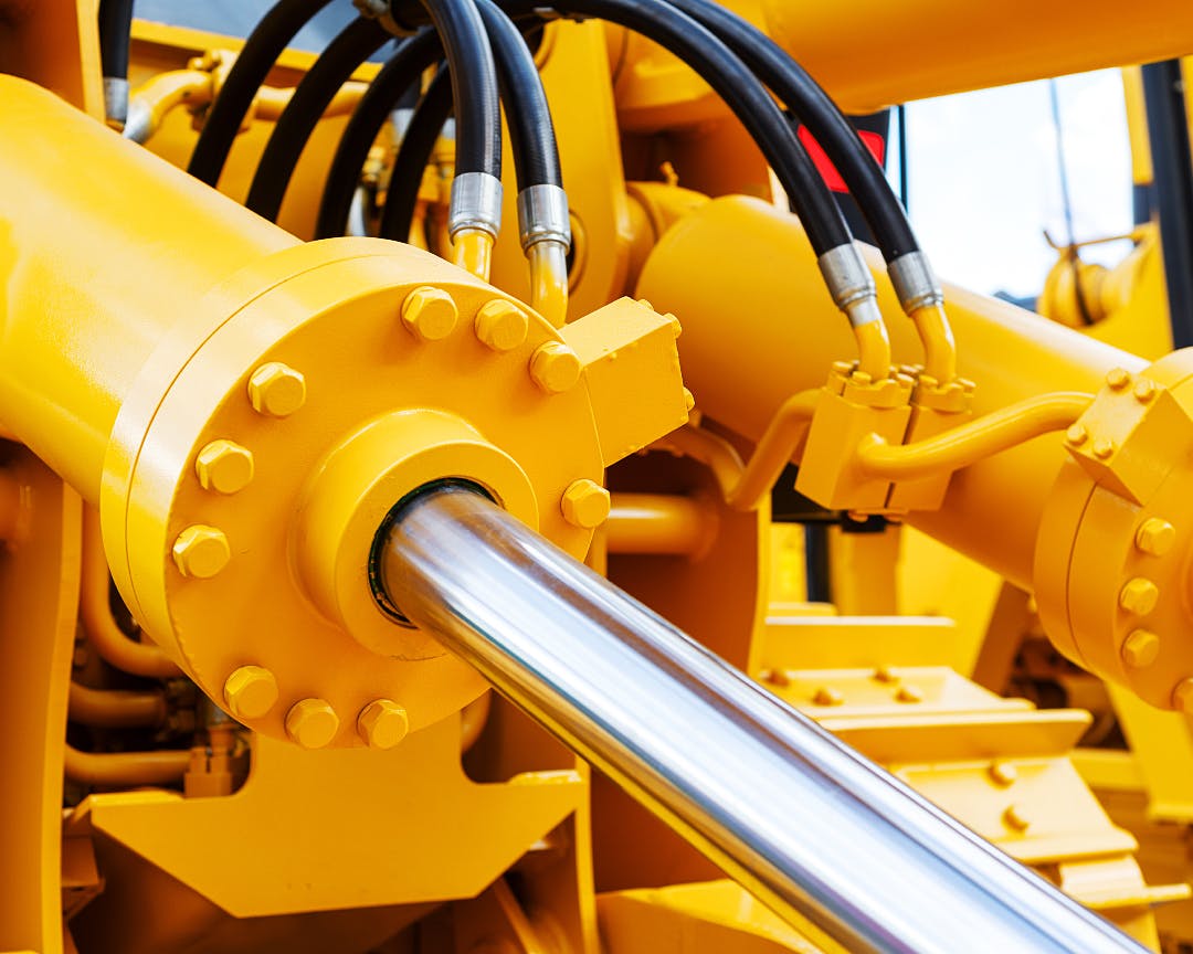 Close up image of yellow hydraulic cylinders