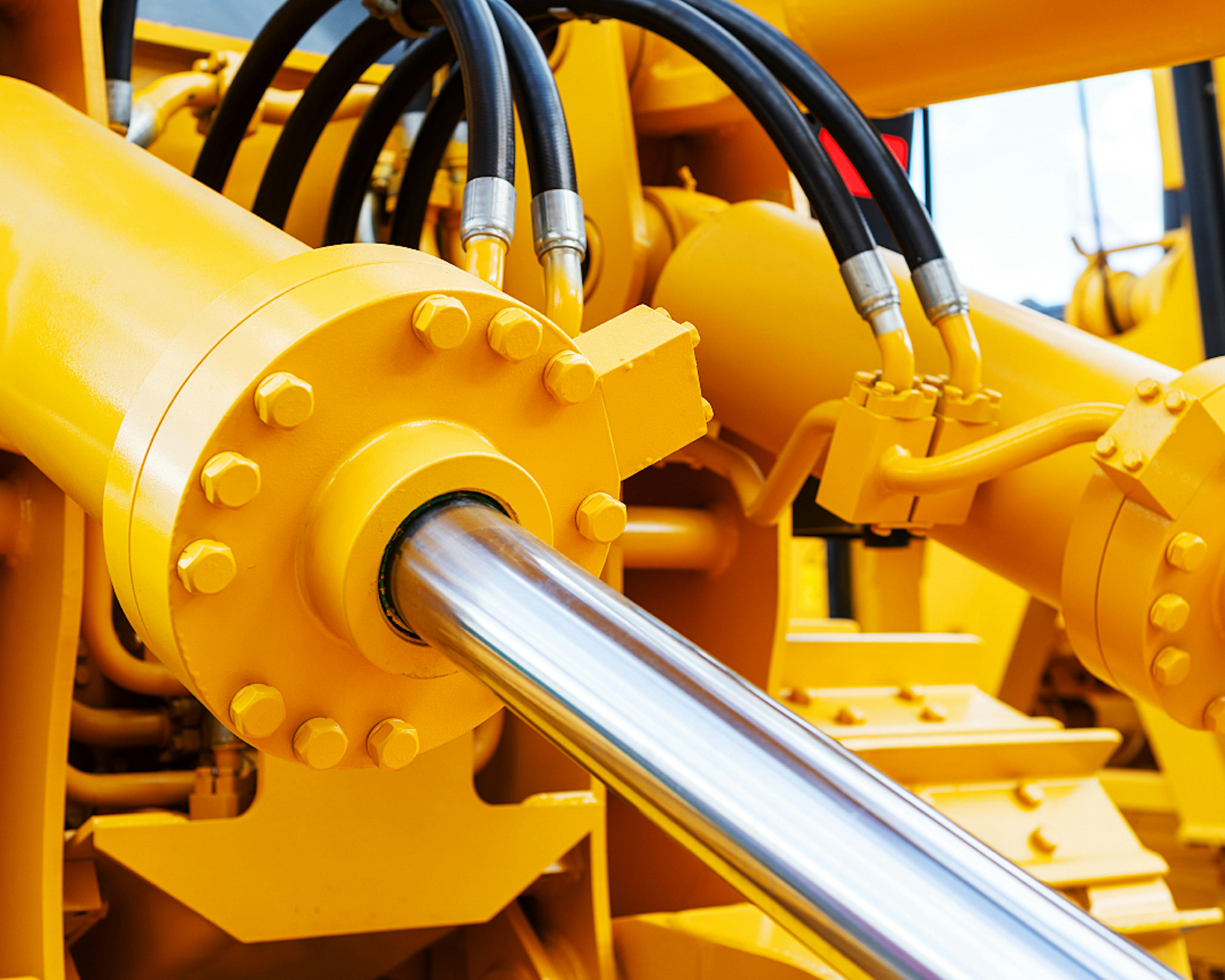 Close up image of yellow hydraulic cylinders