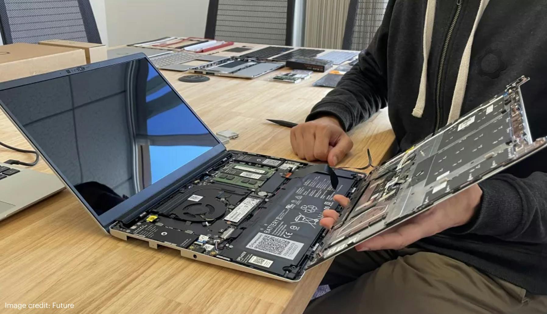 A person with an open Framework Laptop