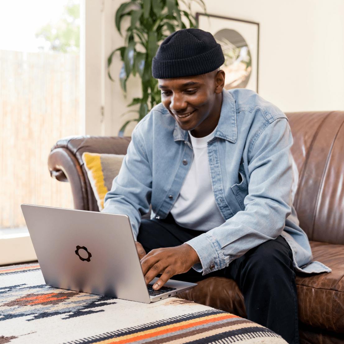 A man using a Framework Laptop on couch