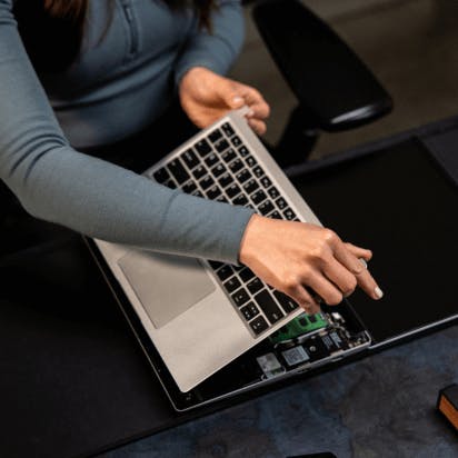 A person assembling a laptop