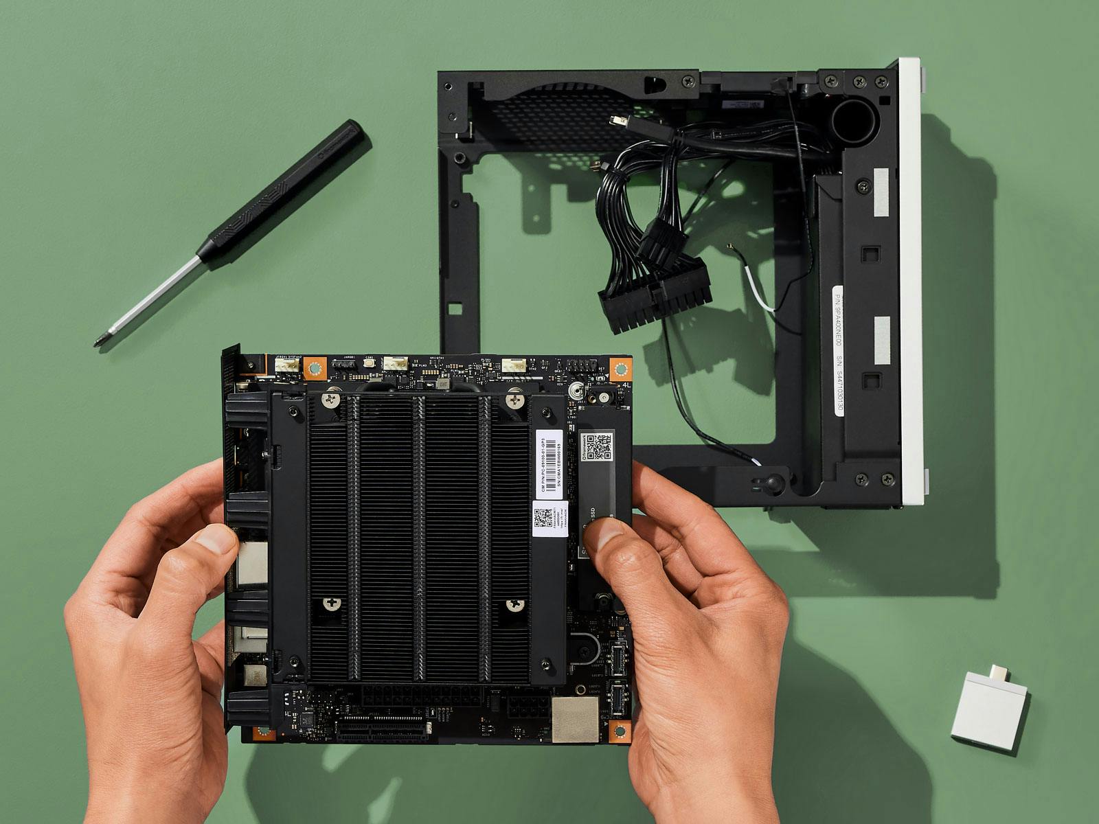 Image of person swapping Framework Desktop Mainboard