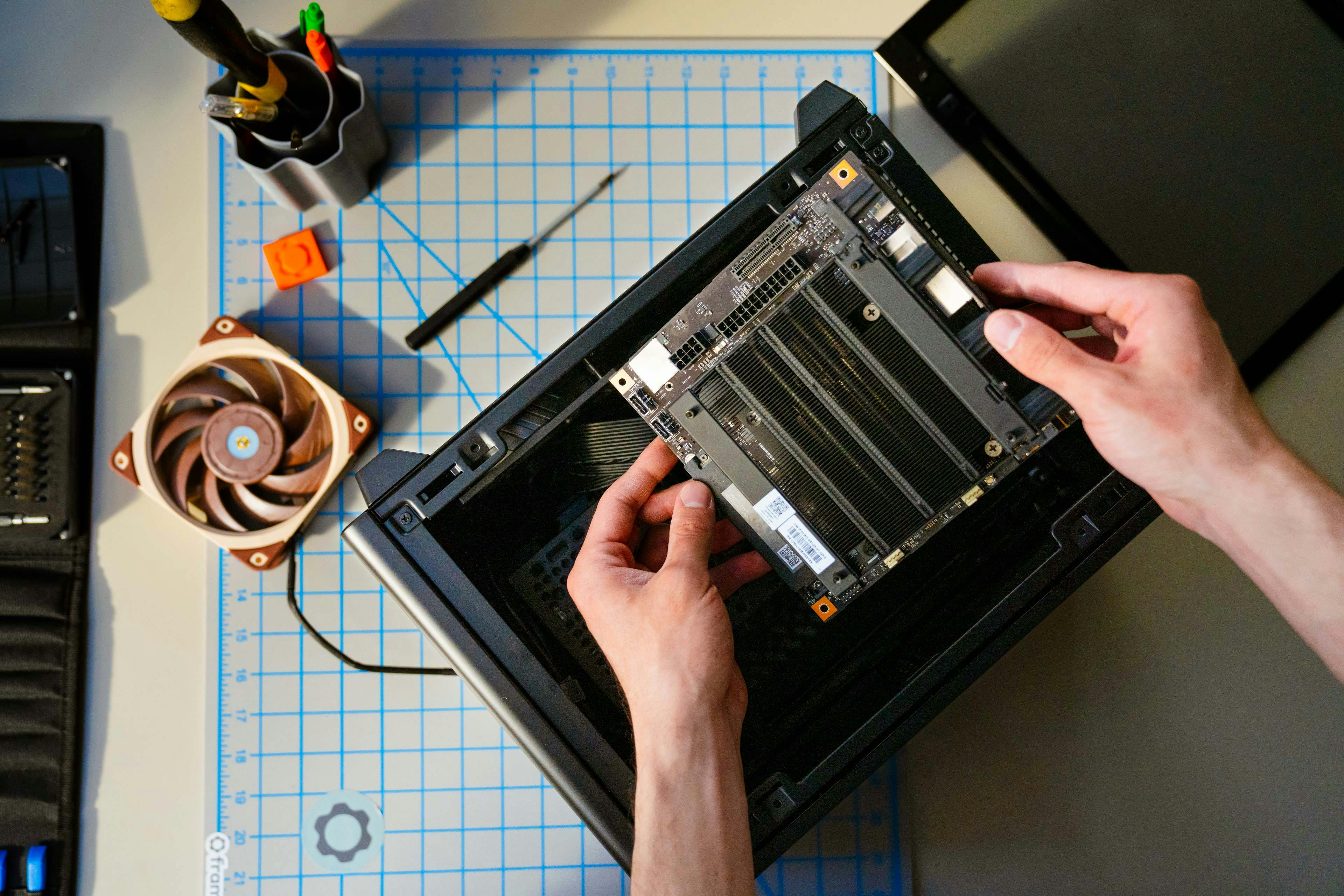 Image of person holding Framework Desktop Mainboard