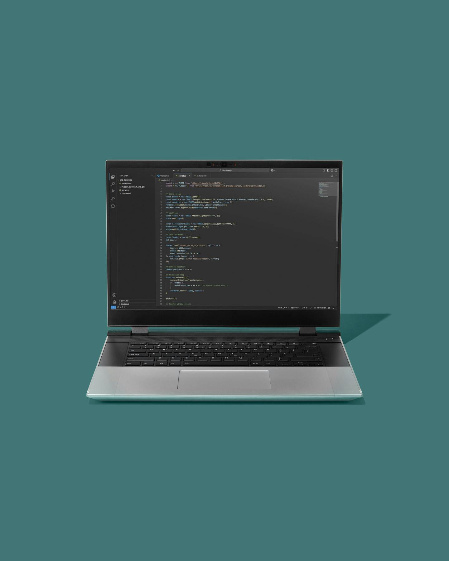 Straight-on studio shot of a Framework Laptop with code on screen placed against a teal backdrop.