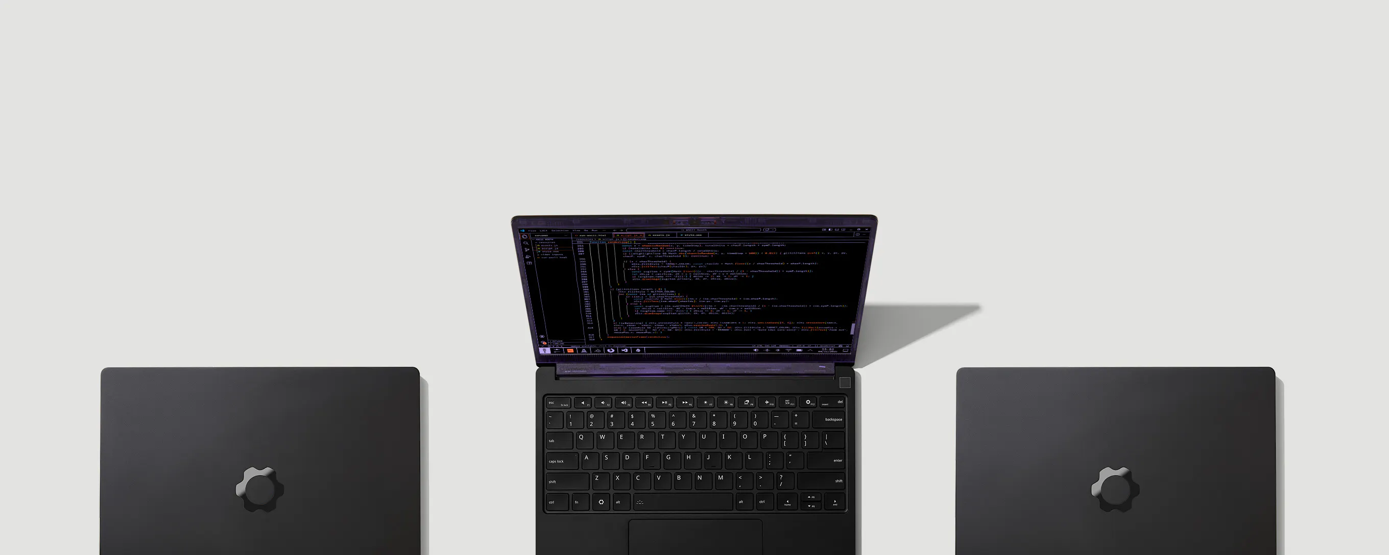 A top-down shot of three Laptop 13 Pros, one opened and the others closed. 