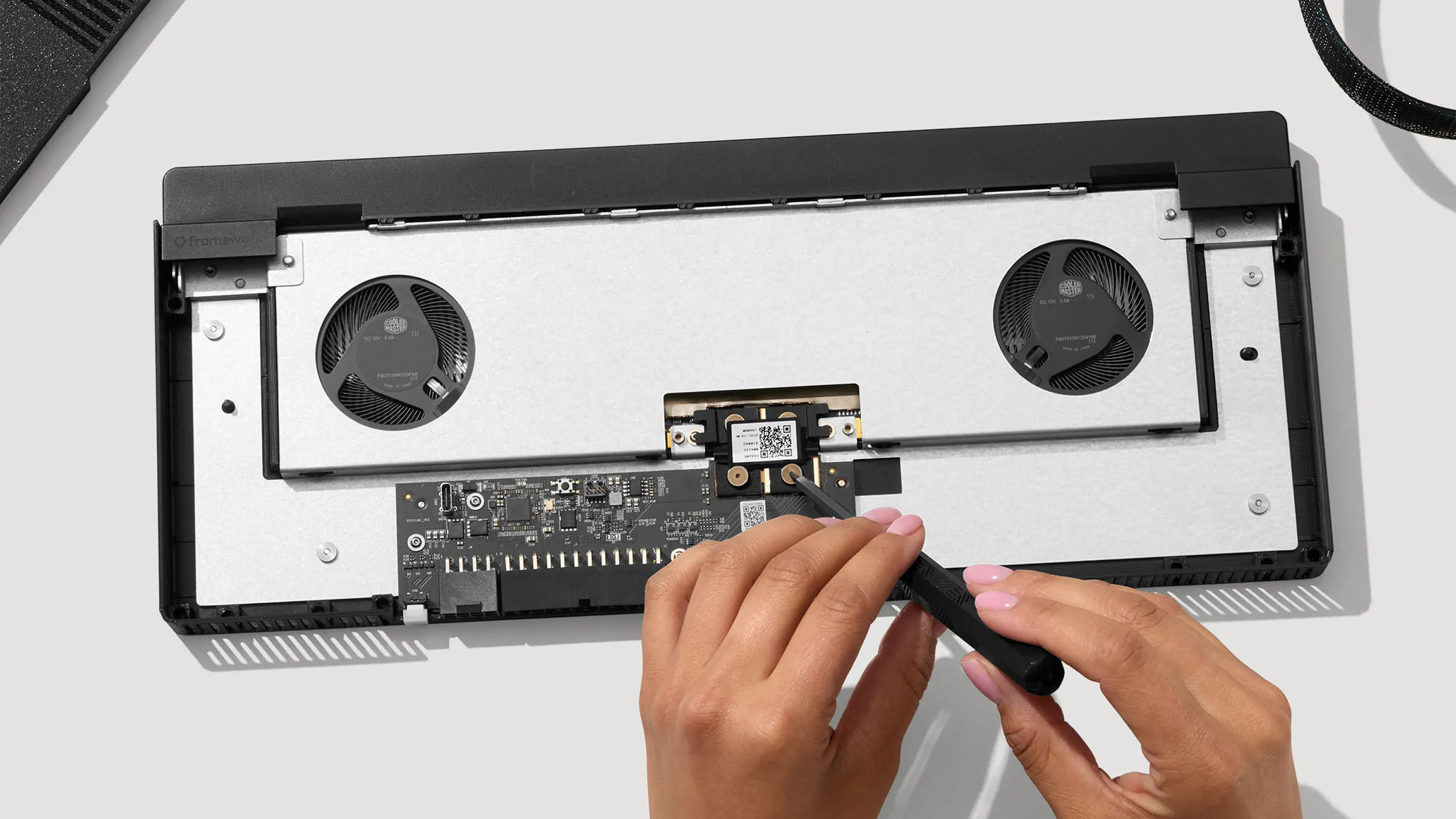 A top-down studio installation shot of a Framework eGPU Mainboard.