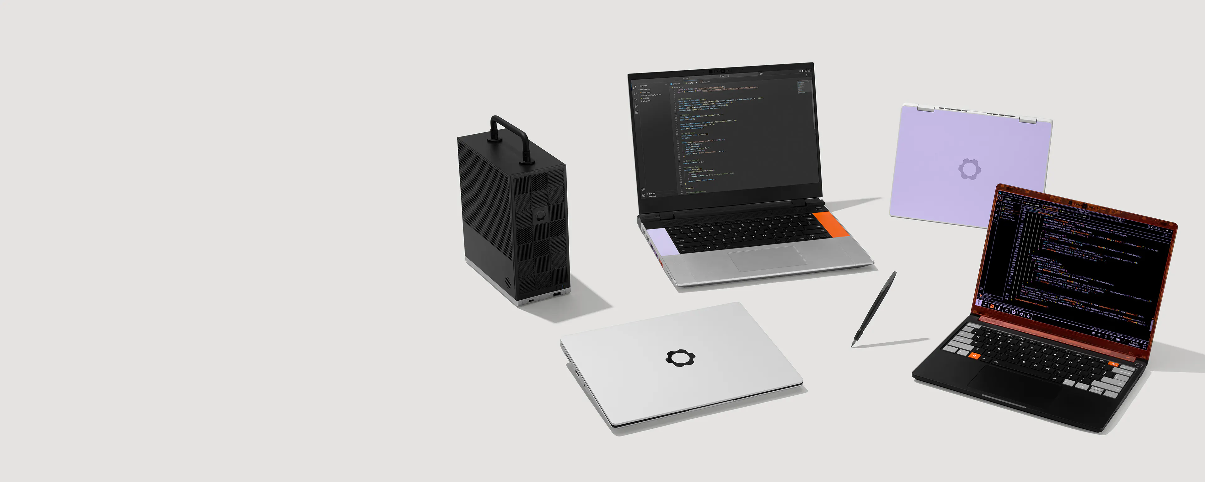 A studio shot of Framework family products: Framework Laptop 16, Framework Laptop 13, Framework Laptop 13 Pro, Framework Laptop 12, Framework Desktop and a FRamework Screwdriver.