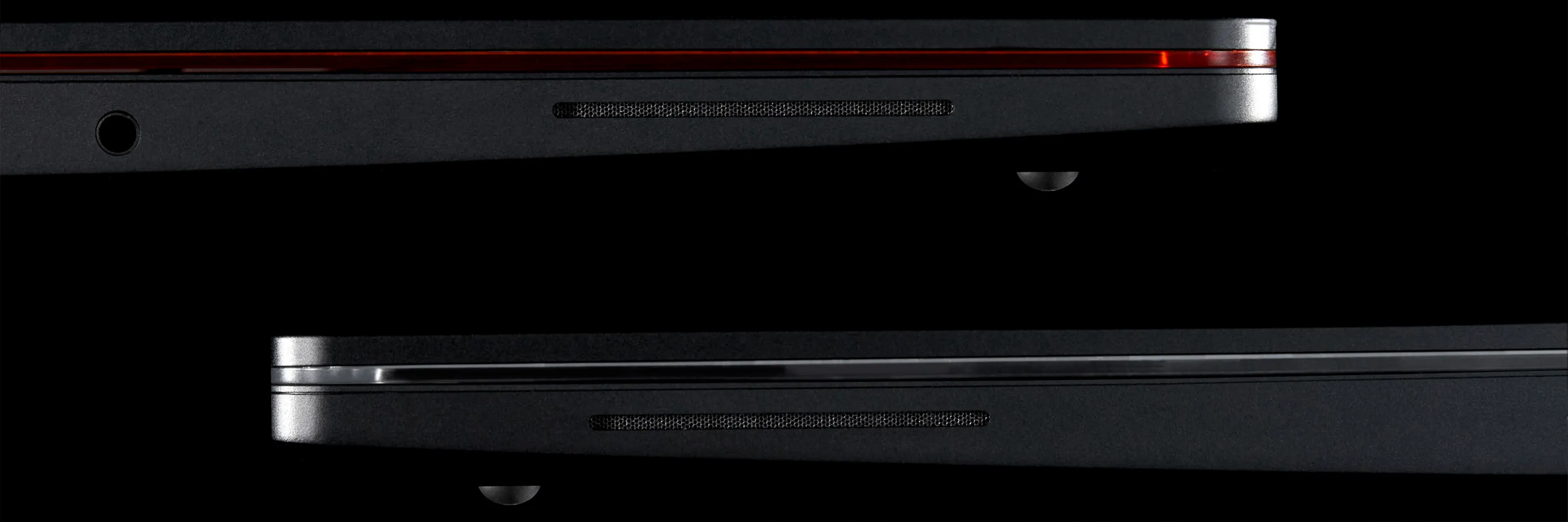 A side angle shot of two 13 Pro Laptops focussing on the side firing speakers.