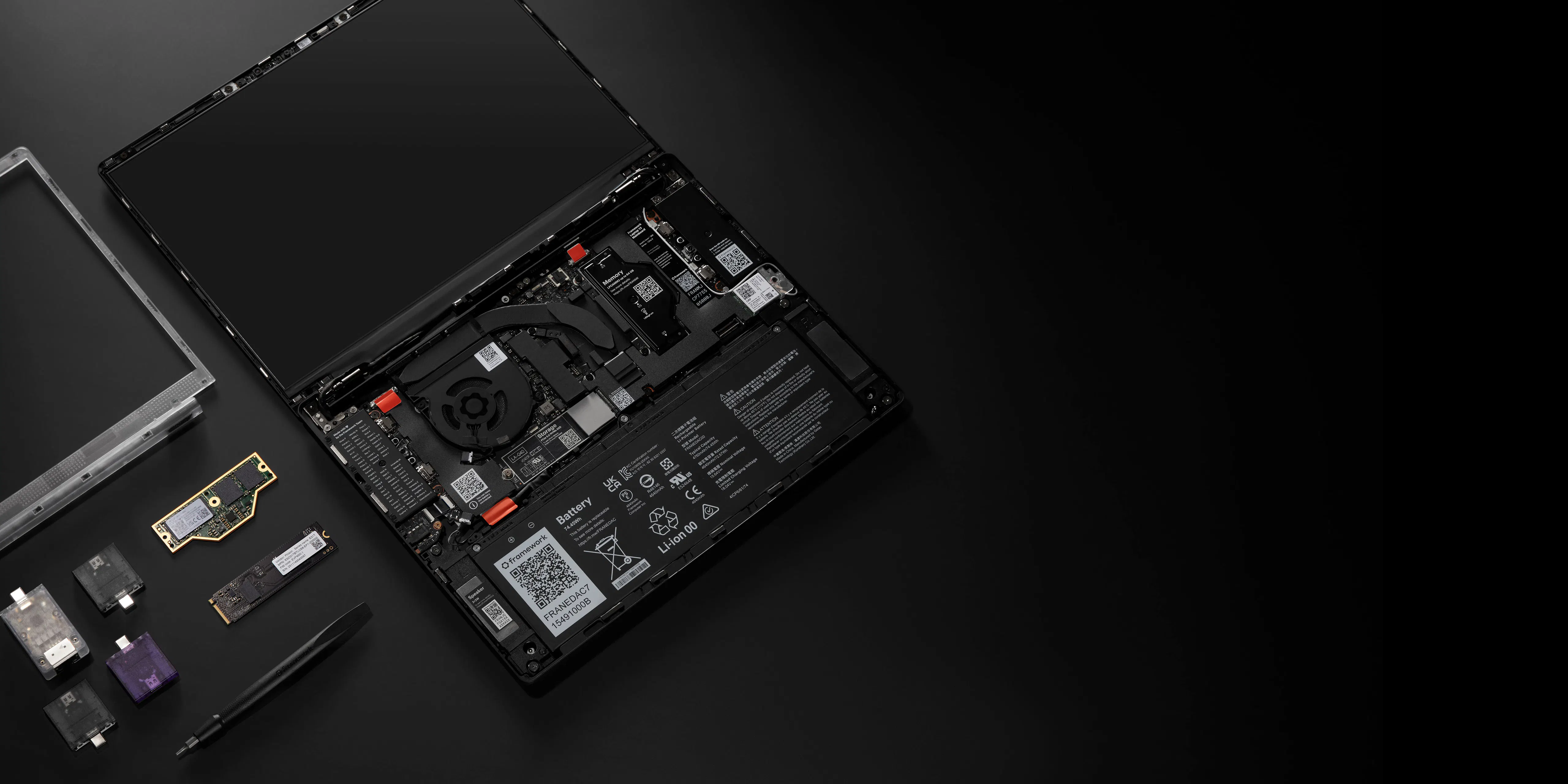A low-light studio shot of disassembled Framework Laptop 13 Pro.